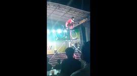 The man fell to the ground while he was performing balance on a bicycle in a circus