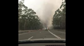Convoy of fire engines drive through smoke filled highway to deliver supplies in New South Wales