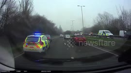 Dashcam footage shows moment car being pursued by police zips wrong way through roundabout then catches fire after colliding with another car