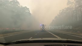 Convoy of fire engines drive through smoke filled highway to deliver supplies in New South Wales