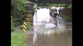water rescue, car is stuck in water under bridge after heavy rains come through