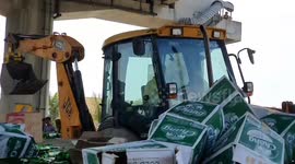 Truck spills hundreds of beer bottles on the road while going round sharp bend