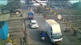 Security cam captures moment biker slams into barrier at level crossing