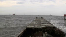 BOATS BREAKING THE WAVES TO COME OUT AND ENTER THE PORT HARBOR