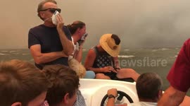 Australians watch their homes burn while evacuating from bushfires on boat