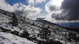 Snowy mountain landscape with clouds