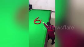 Talented Chinese boy shows off incredible pool trick shots