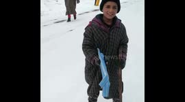 This is the adorable moment a 13-year-old Wasim flaunts off his newly invented skiing technique using scrap plastic pipes.