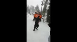 Excavator tumbles from roadside edge while attempting to rescue car after snowfall brings dangerous conditions in Pakistan