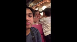 Cheeky toddler steals a kiss at Filipino restaurant