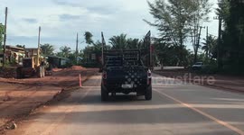 Monkey Rides On Back Of Pickup Truck