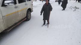 Innovative 13-year-old uses scrap piping as pair of skis to slide down icy road in northern India