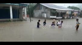 Children play in floodwaters as heavy rains hit Padang, Indonesia