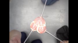 Three molten glass bubbles unite into one satisfying sphere