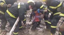 Chinese firefighters free two children that were stuck in thick mud