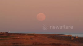 First full moon of 2020 - known as wolf moon - seen rising over seaside town in Essex, UK