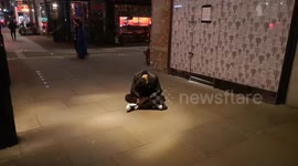 Drunk Sits On The Floor On A Friday Night In Central London
