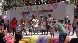 Two deers join in the dancing at a children's day party at a temple grounds in Pathumthani, Thailand.