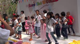 Very lively energetic children dancing at a children's day party at a temple in Thailand.