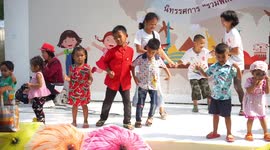 Children having great fun at a children's day party at a temple grounds in Thailand.