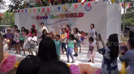 The children's day party at a Buddhist temple in Thailand, gets into full swing as more and more energetic children join in the fun.