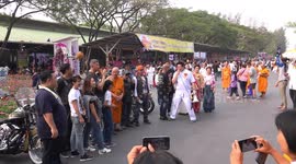 Buddhist monks and Harley Davison bikers at a children's day party, held at the grounds of a Thai temple.