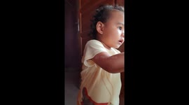 18-month-old girl in style in front of the camera