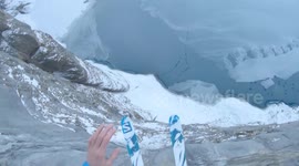 Heart-stopping moment two base jumpers take leap of faith and ski off icy mountain in Switzerland