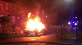This dramatic footage and series of images shows a car engulfed by flames on a residential street last night