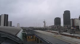 Heavy rain falls at a distance over London as seen from Stratford