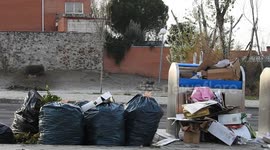 Garbage bags and cardboard outside the containers