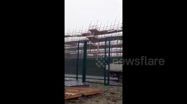 Shocking moment construction blows over due to Storm Brendan's winds in Ireland