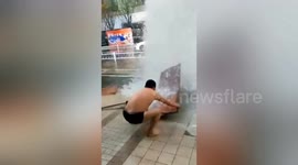 Chinese plumber attempts to repair broken fire hydrant in just his underwear