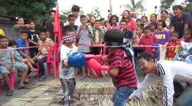 Children play blindfolded boxing game in Thailand