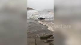 Dramatic footage shows car submerged in high tide after Storm Brendan batters UK