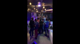 Man jump slaps another man in club fight.