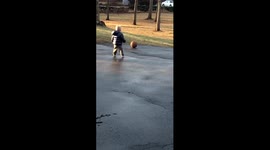 US toddler looks distraught after failing to stop his basketball roll down the hill