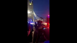 Police on scene as man slides down London's famed Tower Bridge