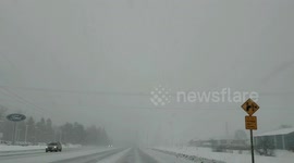 Intense snowstorm covers Michigan highway