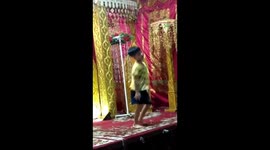 a child in the field was very excited to sway while listening to dangdut remix music
