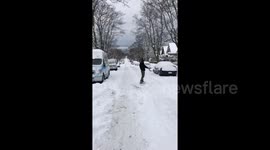 'Only way to get to work in Vancouver!' Woman snowboards down icy street in Canada