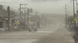 Taal Volcano Crisis - Volcanic Ash Blows Across Road In Strong Wind