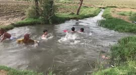 Kids bathing and having fun in a tiny mini pond swimming pool
