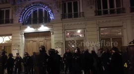Scores of protesters gather outside theatre attended by Macron