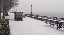 NYC: Snow shower whitens Hudson River Esplanade