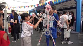 Japanese inventor shows off dancing skeleton suit at Thai tech convention