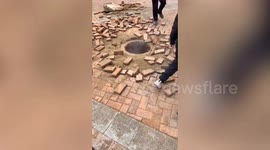 Manhole explodes in China after girl drops firecrackers through cover