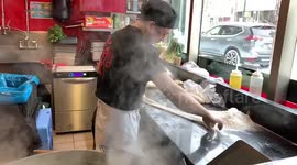 Chef prepares noodles in Montreal Chinatown