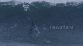 Pro surfer Kai Lenny does 360 in the middle of riding 40-foot wave in Portugal