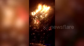 Multi-storey textile building engulfed in burning inferno as more than 50 fire engines rush to control situation in western India